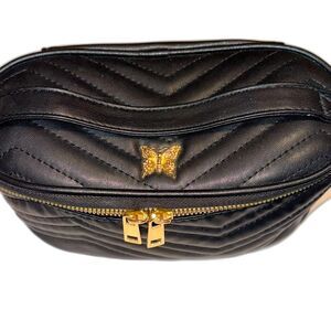 Black quilted oval cosmetic bag